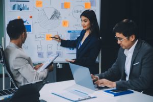 group-confident-business-people-point-graphs-charts-analyze-market-data-balance-sheet-account-net-profit-plan-new-sales-strategies-increase-production-capacity-min